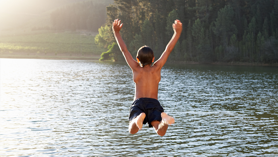 Boy Jumping Into Lake